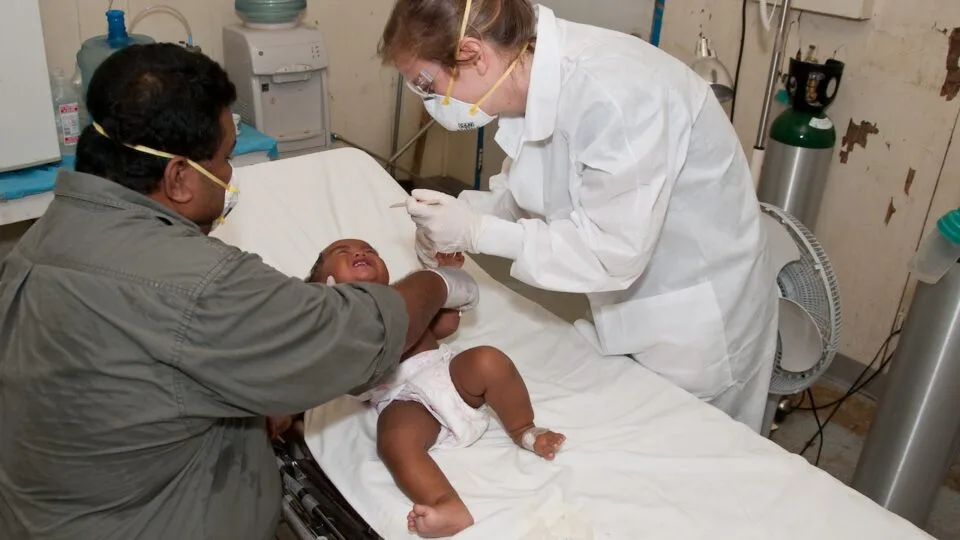 Exame clínico do abdômen e avaliação de edema em paciente pediátrico com glomerulonefrite pós-estreptocócica